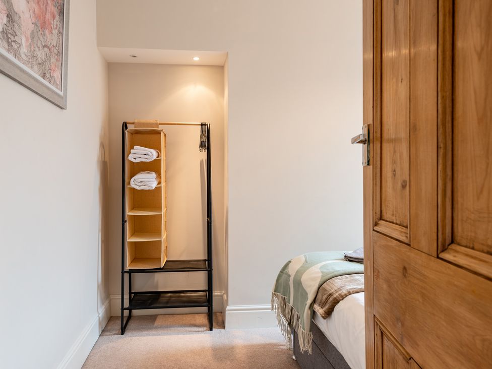 A bedroom with a towel rack and bed at 18 Mayville Avenue Scarborough