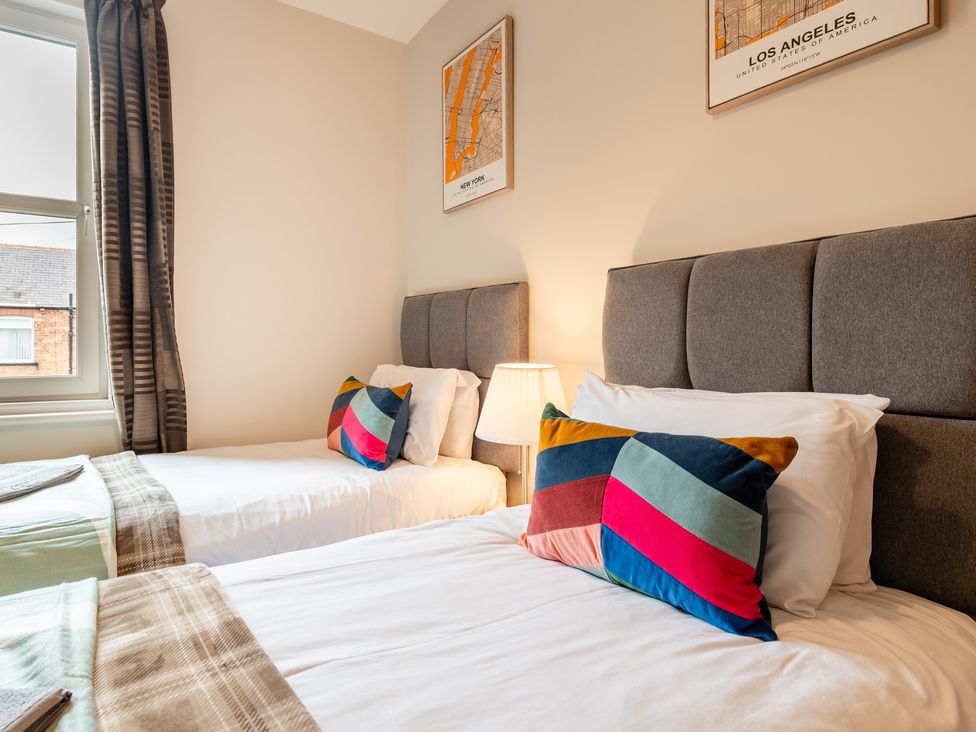 A bedroom with two beds and wall art at 18 Mayville Avenue, Scarborough