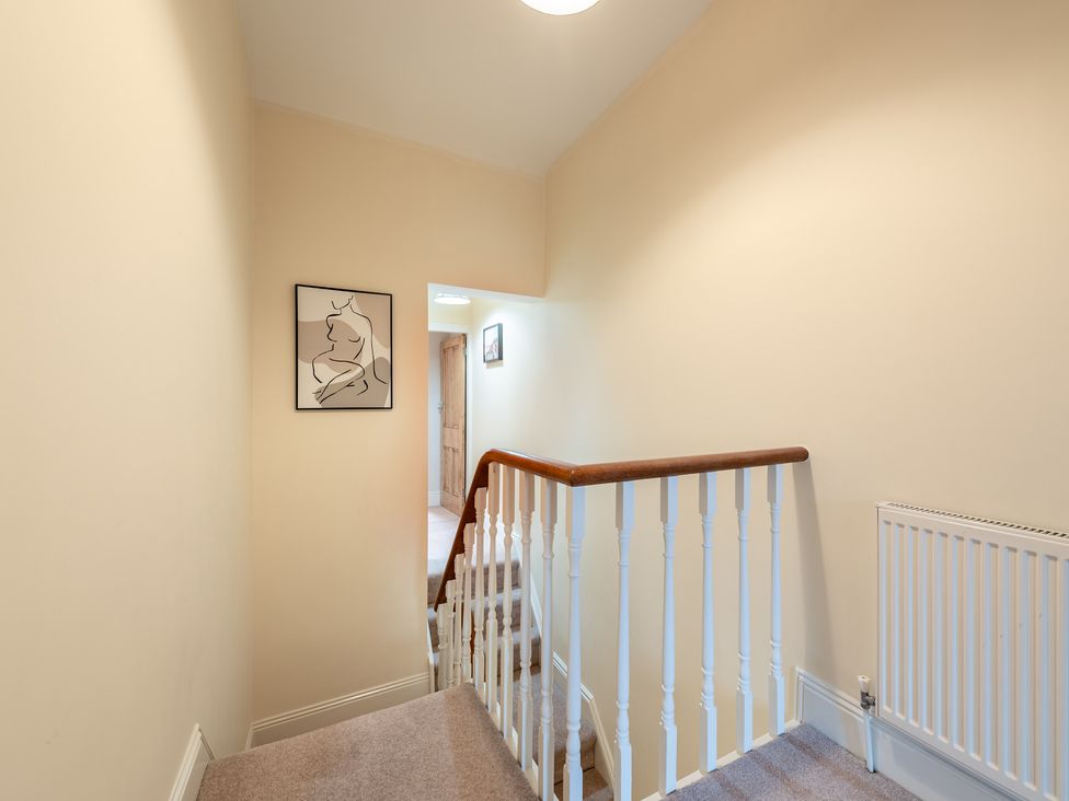A hallway with a staircase and artwork on the wall at 18 Mayville Avenue, Scarborough