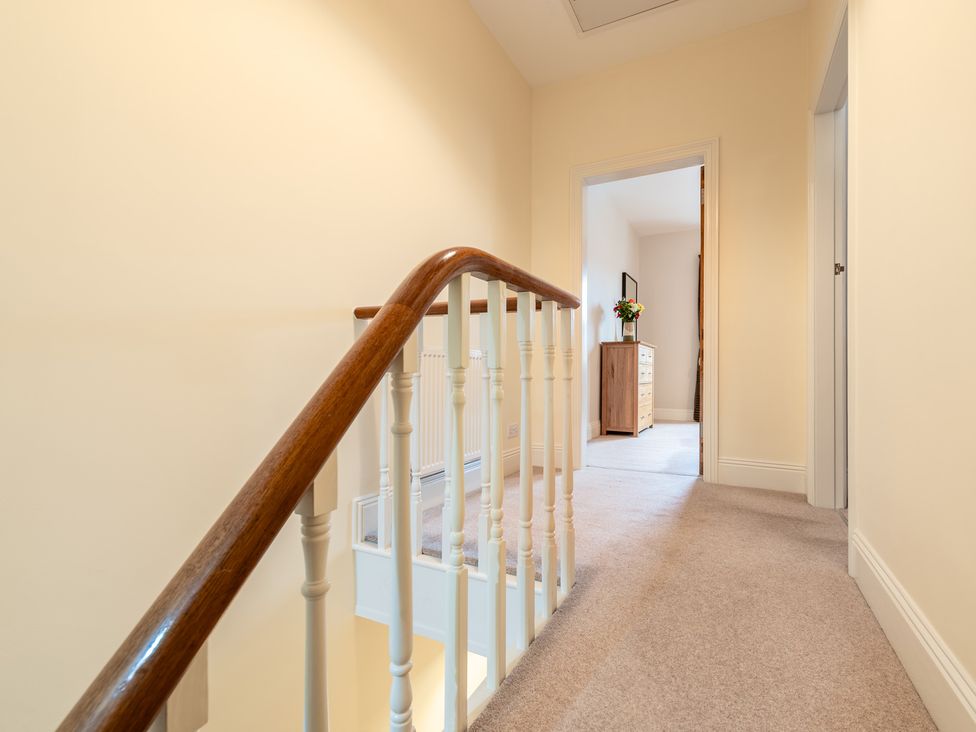 A hallway with a staircase and chest of drawers at 18 Mayville Avenue Scarborough