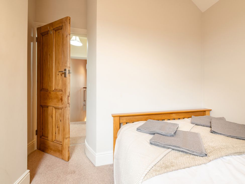 A bedroom with a bed and door at 18 Mayville Avenue in Scarborough