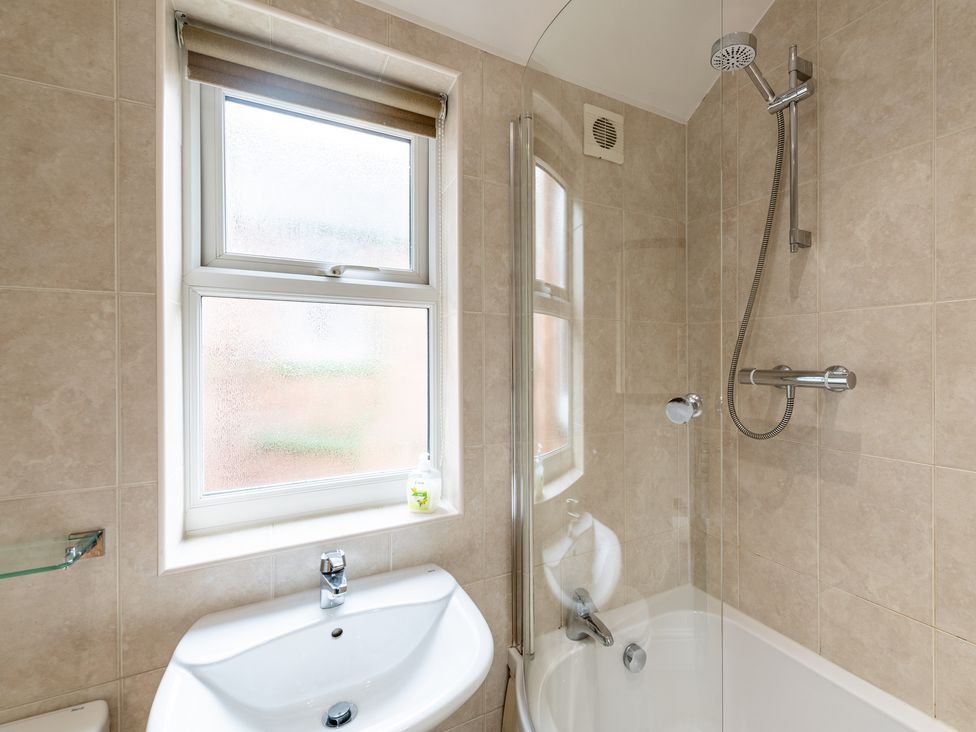 A bathroom with a bathtub and shower at 18 Mayville Avenue, Scarborough