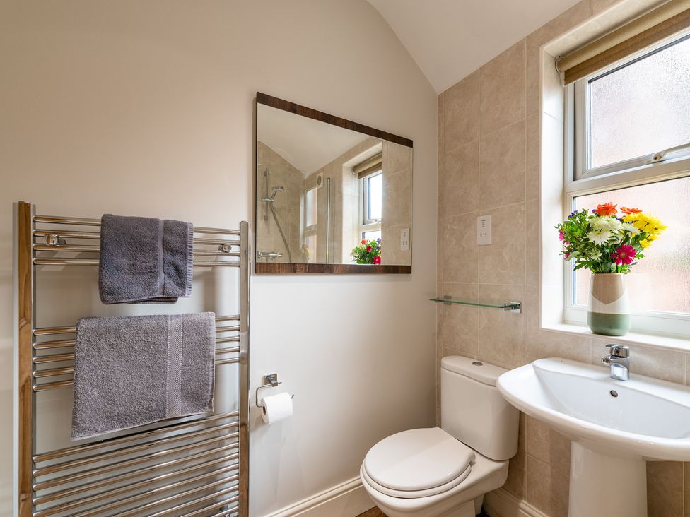 A bathroom with a towel warmer and a mirror at 18 Mayville Avenue Scarborough