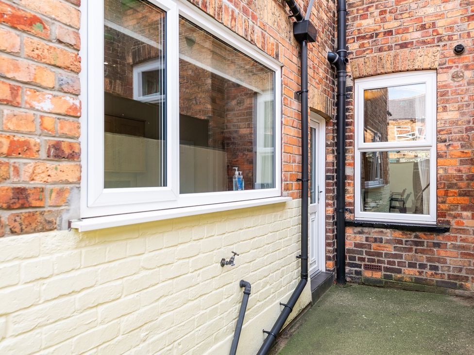 An outdoor area with brick walls and windows at 18 Mayville Avenue, Scarborough