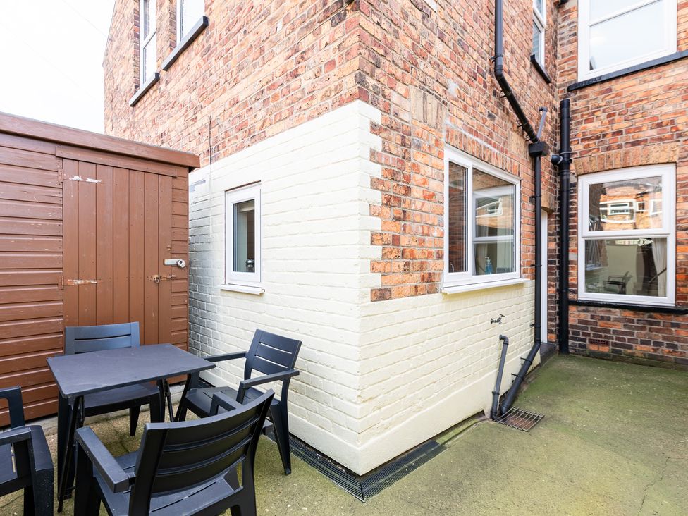 A garden with a table and chairs next to a shed at 18 Mayville Avenue in Scarborough