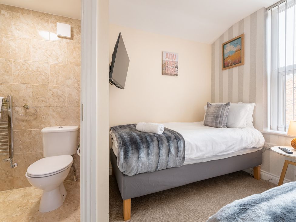 A bedroom with a bed and a bathroom including a toilet at 125 Columbus Ravine, Scarborough