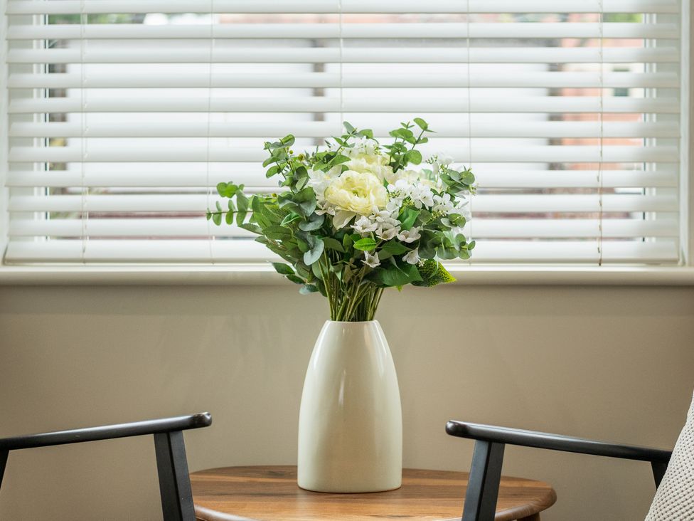 A flower arrangement in a vase on a table in a living room at 125 Columbus Ravine in Scarborough