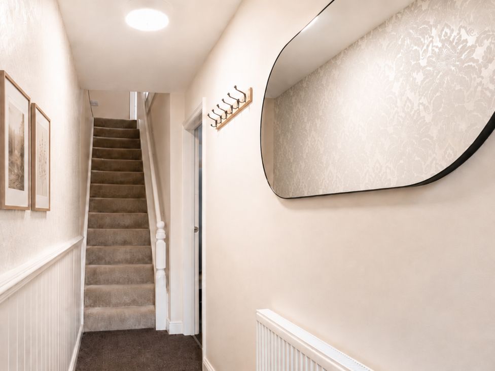 A hallway with stairs and a mirror at 125 Columbus Ravine in Scarborough