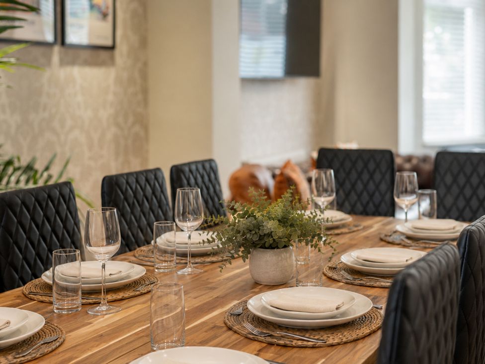 A dining room with a table set up for a meal at 125 Columbus Ravine Scarborough