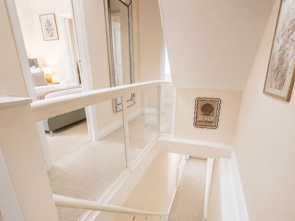A hallway with a staircase and a mirror at 125 Columbus Ravine, Scarborough
