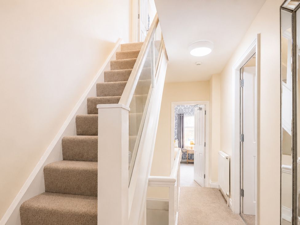 A hallway with stairs, a mirror, and doors at 125 Columbus Ravine Scarborough