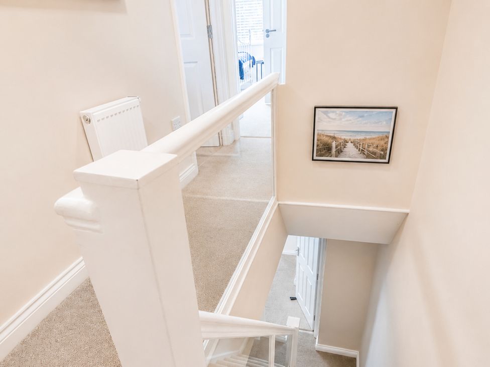A staircase with a handrail and a picture at 125 Columbus Ravine in Scarborough