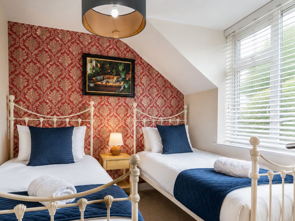 A bedroom with two beds and a bedside table at 125 Columbus Ravine in Scarborough