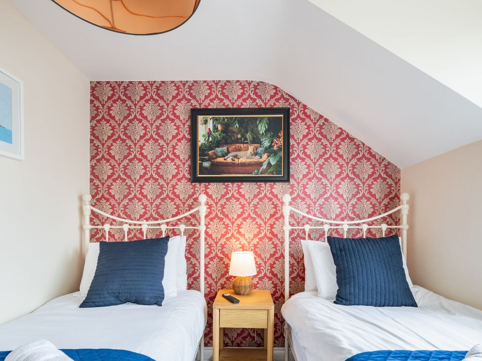 A bedroom with two beds and a lamp on a nightstand at 125 Columbus Ravine, Scarborough