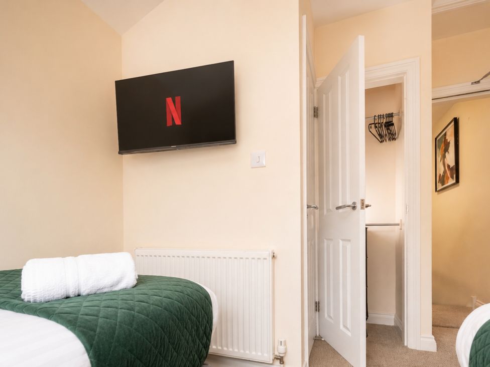 A bedroom with a television and towel at 125 Columbus Ravine, Scarborough