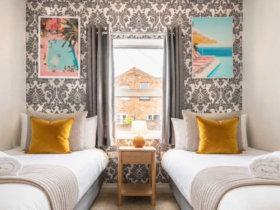 A bedroom with twin beds and wall art at 125 Columbus Ravine, Scarborough