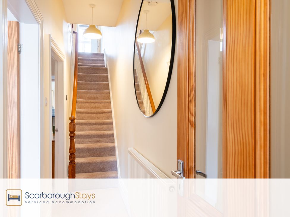 A hallway with a staircase and mirror at 125 Columbus Ravine Scarborough