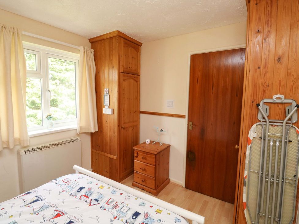 A bedroom with a bed and chest of drawers at Cottage 28 in Brixham