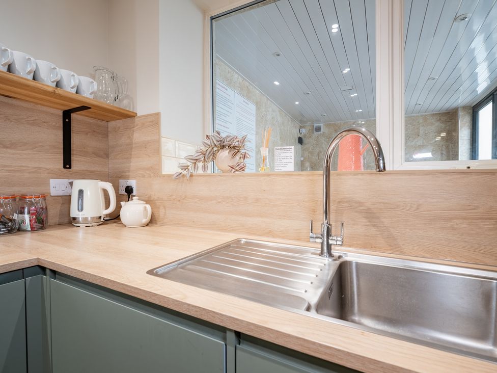 A kitchen counter with a kettle and sink at 127 Columbus Ravine in Scarborough