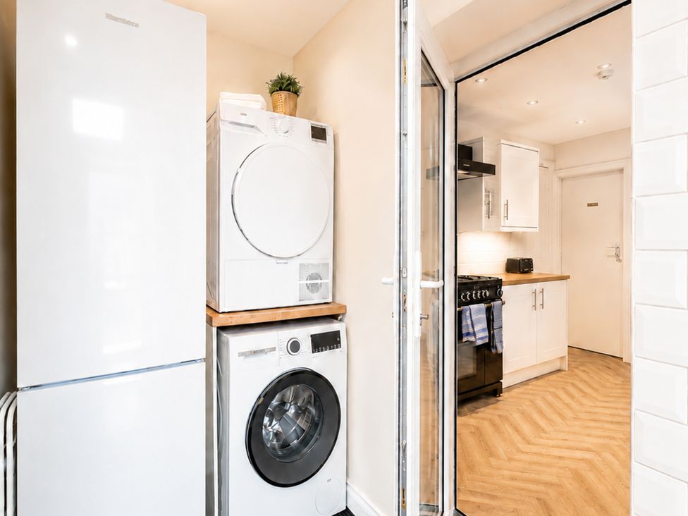 A laundry room with appliances and kitchen access at 127 Columbus Ravine Scarborough