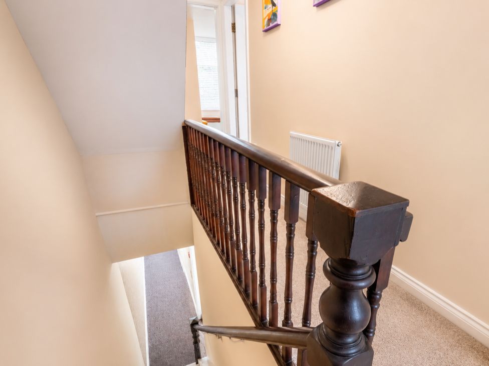 A staircase with a banister and a radiator at 127 Columbus Ravine Scarborough