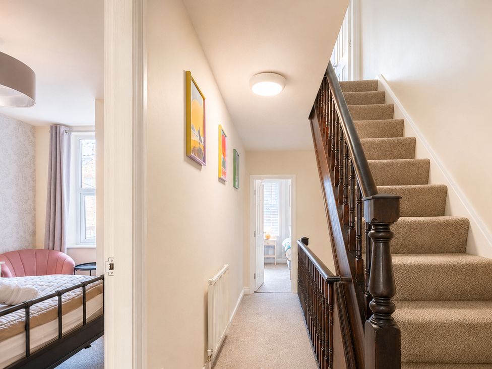 A hallway with a staircase and a bed in a room at 127 Columbus Ravine Scarborough