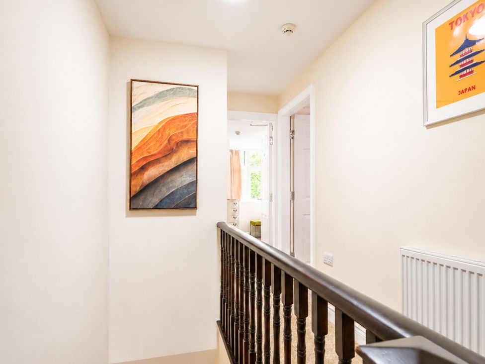 A hallway with a staircase and painting at 127 Columbus Ravine in Scarborough