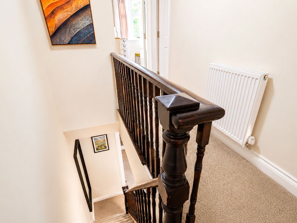 A staircase with a banister and radiator in a hallway at 127 Columbus Ravine, Scarborough