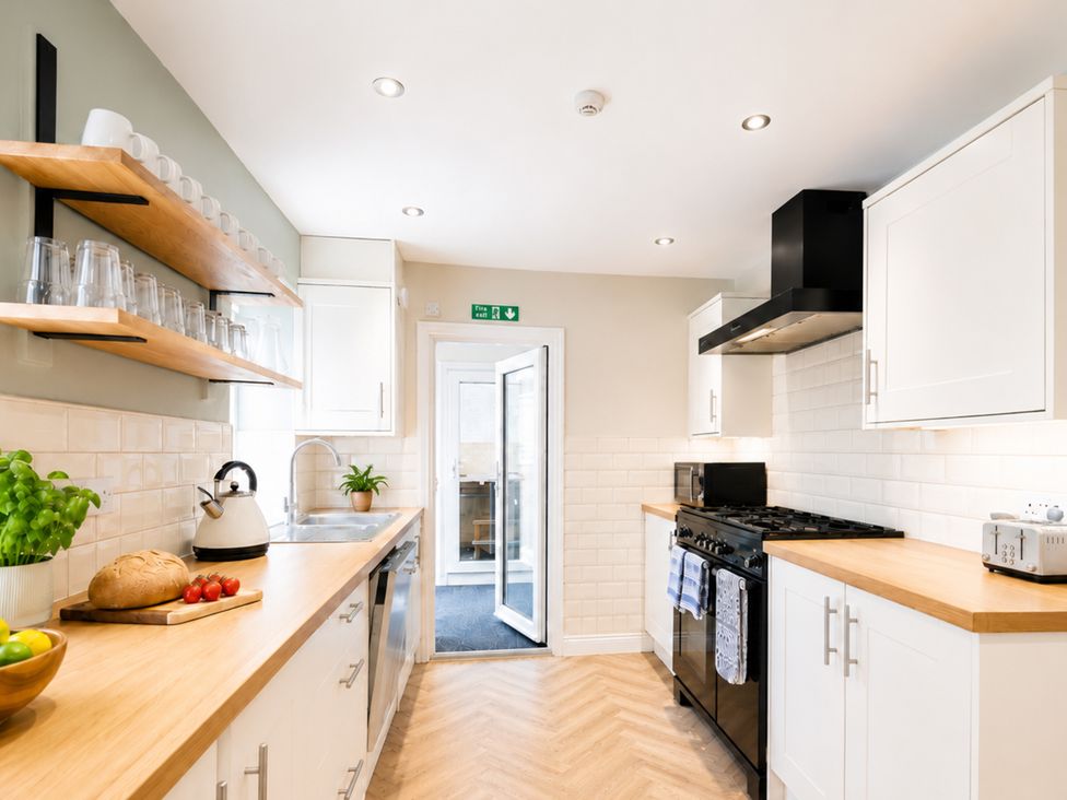 A kitchen with shelves and modern appliances at 127 Columbus Ravine in Scarborough