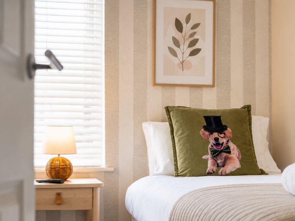 A bedroom with a dog pillow and lamp at 127 Columbus Ravine, Scarborough