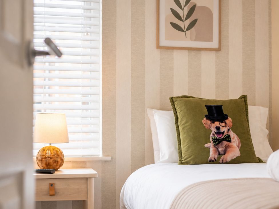A bedroom with a dog pillow and lamp at 127 Columbus Ravine in Scarborough