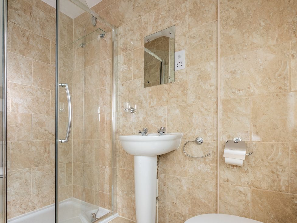 A bathroom with a shower, sink, and toilet at 127 Columbus Ravine, Scarborough