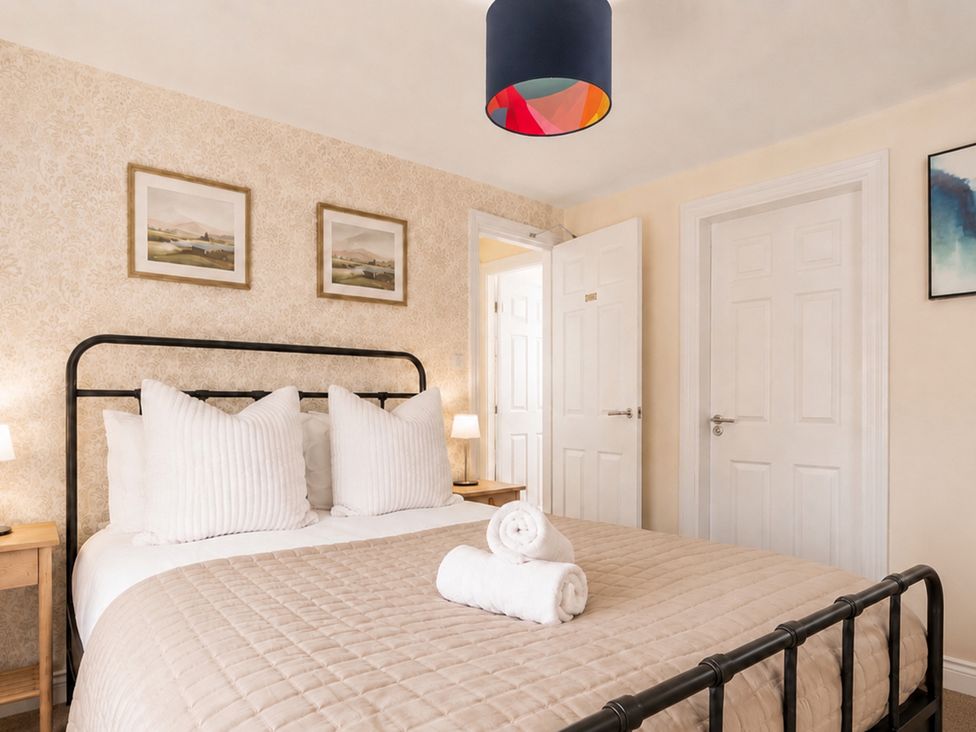 A bedroom with a bed and artwork on walls at 127 Columbus Ravine in Scarborough