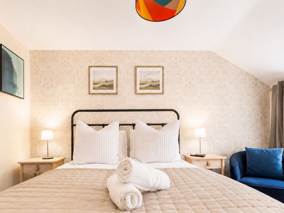 A bedroom with a bed, side tables, and art on the wall at 127 Columbus Ravine, Scarborough