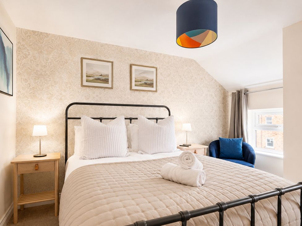 A bedroom with a bed and bedside lamps at 127 Columbus Ravine in Scarborough