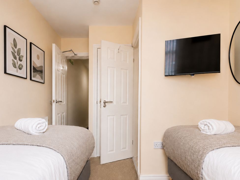 A bedroom with two beds and a television at 127 Columbus Ravine in Scarborough