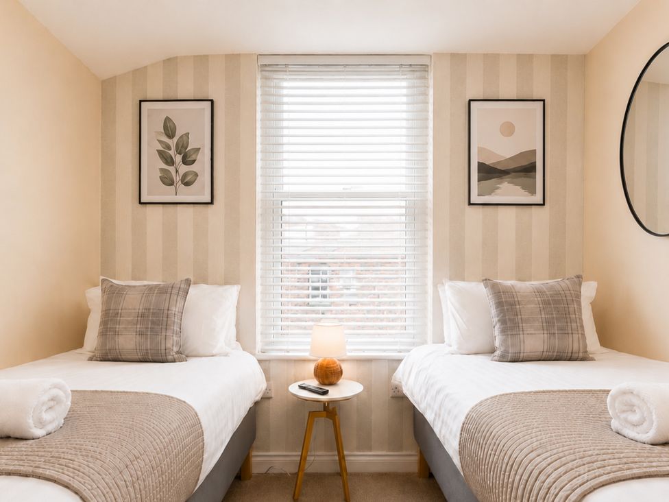 A bedroom with two beds and a side table at 127 Columbus Ravine, Scarborough