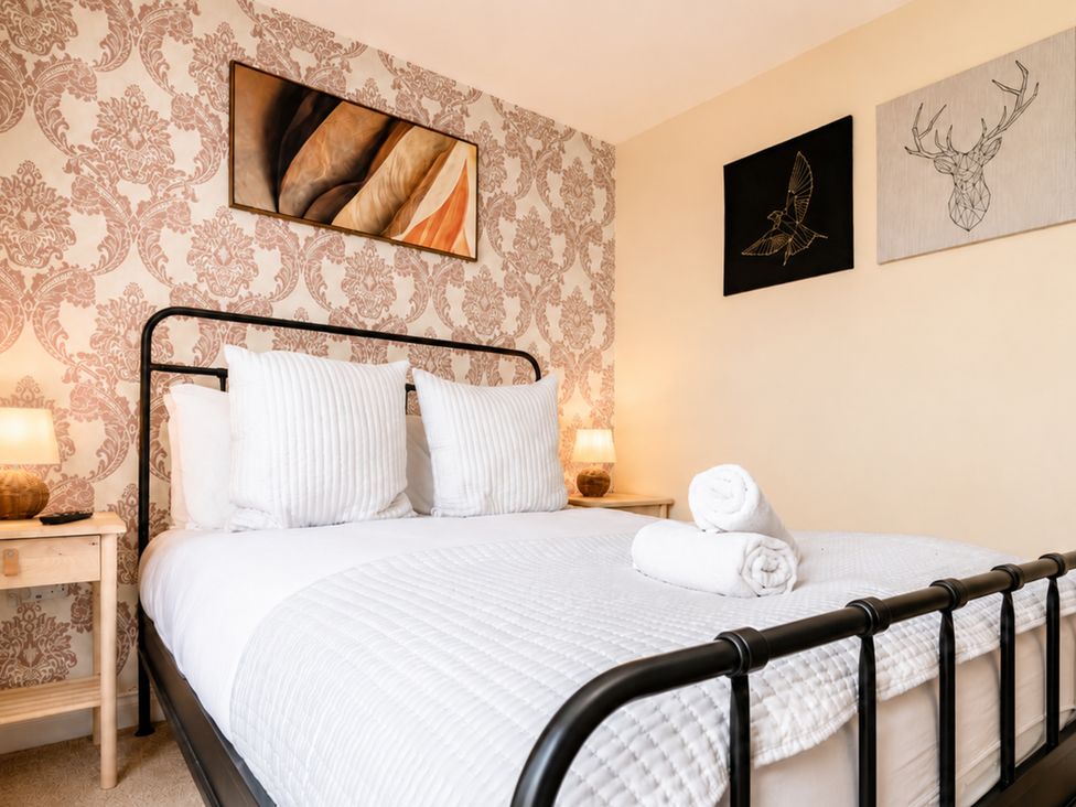 A bedroom with a bed and wall art at 127 Columbus Ravine, Scarborough