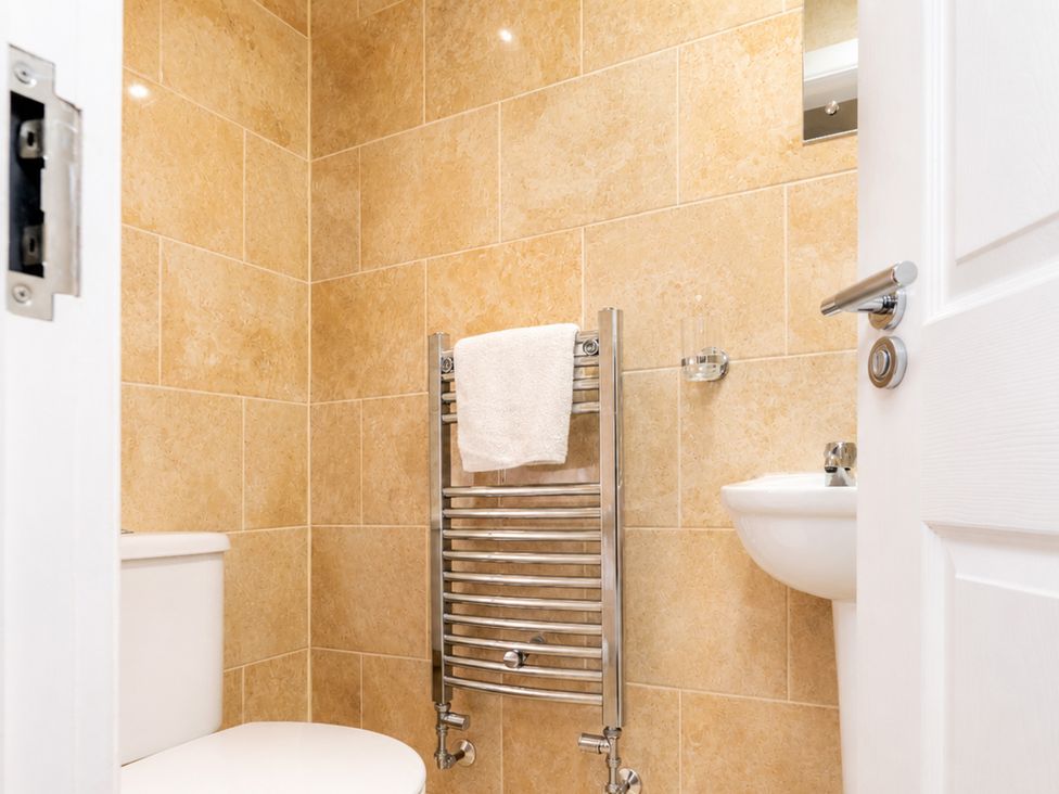 A bathroom with a toilet, sink, and towel rail at 127 Columbus Ravine Scarborough