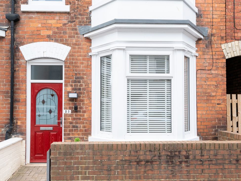 A house exterior with a red door and bay window at 23 Trafalgar Road in Scarborough