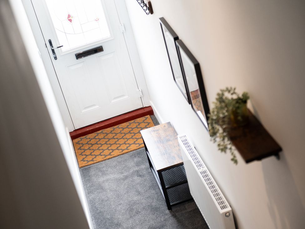 A hallway with a front door and a console table at 23 Trafalgar Road Scarborough