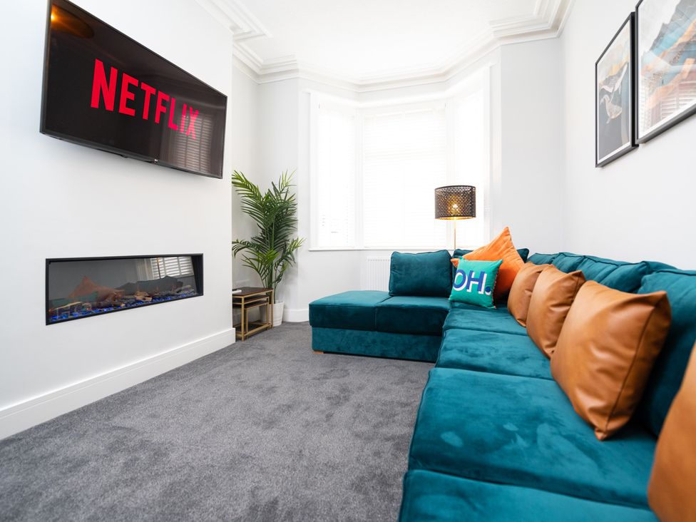 A living room with a television and sofa at 23 Trafalgar Road in Scarborough