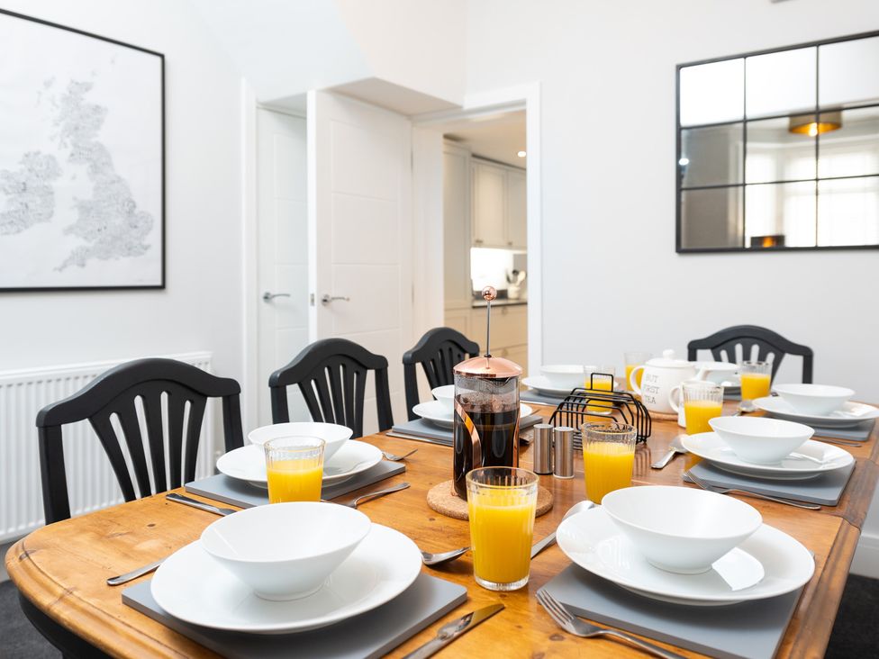 A dining room with a table set for breakfast at 23 Trafalgar Road in Scarborough