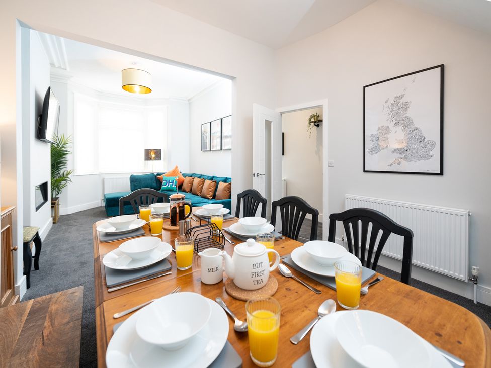 A dining table set with plates and drinks at 23 Trafalgar Road in Scarborough