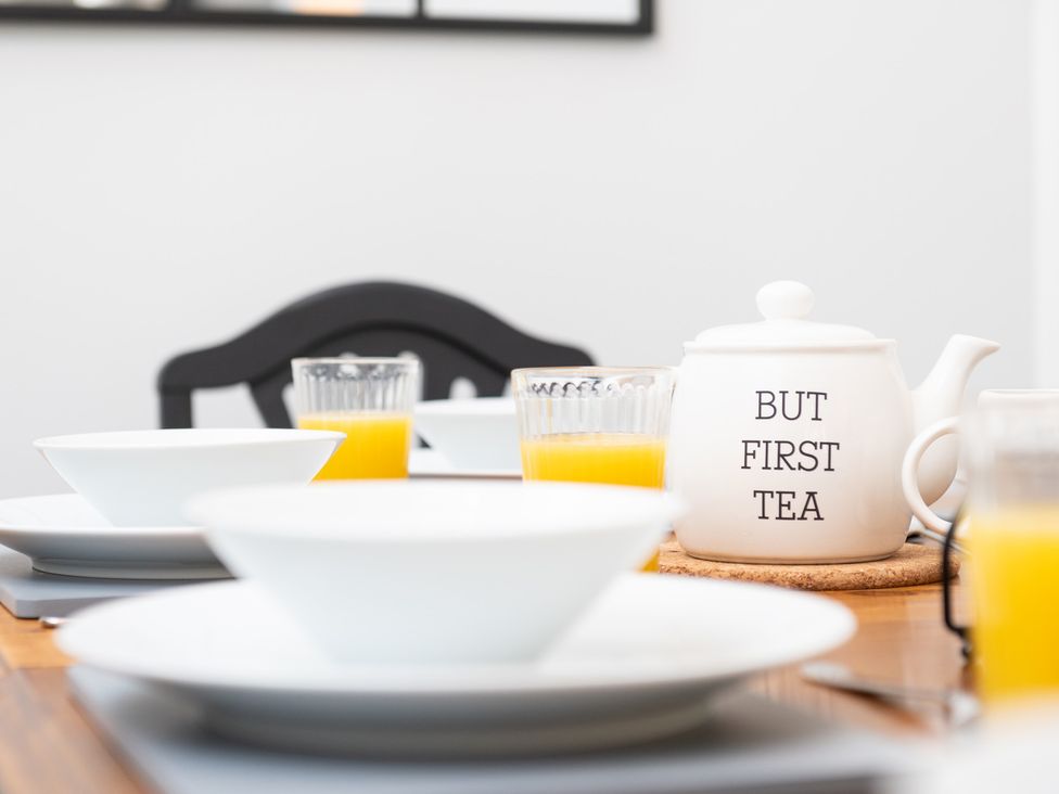 A dining table set with a teapot and glasses of juice at 23 Trafalgar Road, Scarborough