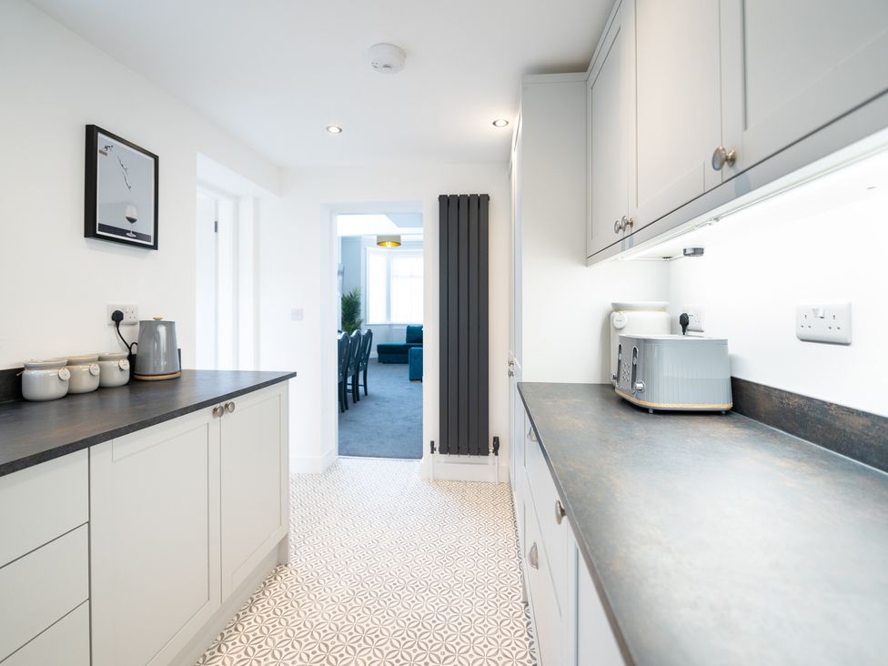 A kitchen with cabinets and appliances at 23 Trafalgar Road, Scarborough