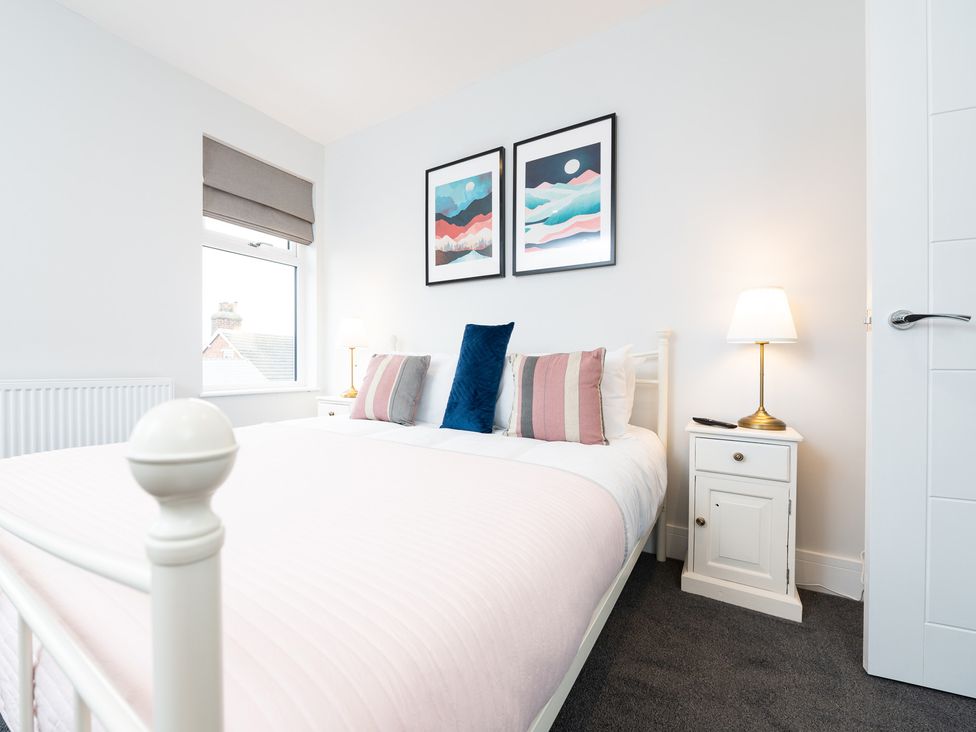 A bedroom with a bed and side table at 23 Trafalgar Road in Scarborough