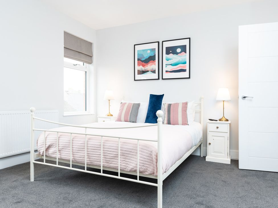A bedroom with a bed and artwork on the wall at 23 Trafalgar Road in Scarborough