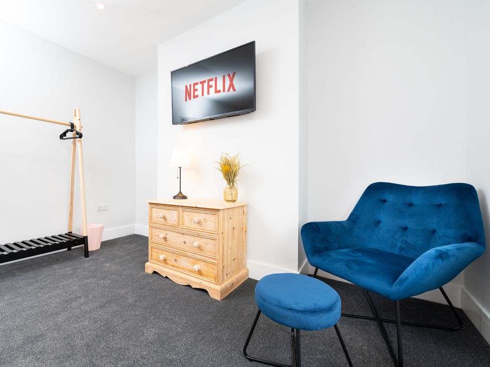 A living room with a television, armchair and chest of drawers at 23 Trafalgar Road in Scarborough