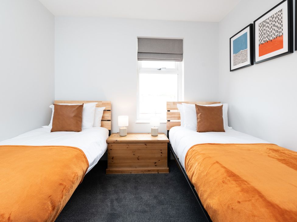 A bedroom with two beds and a window at 23 Trafalgar Road in Scarborough